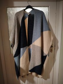 Monsoon Colourblock Knit Poncho. The design features an abstract, geometric color-block pattern with shades of blue, grey, and cream and Navy.