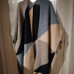 Monsoon Colourblock Knit Poncho. The design features an abstract, geometric color-block pattern with shades of blue, grey, and cream and Navy.