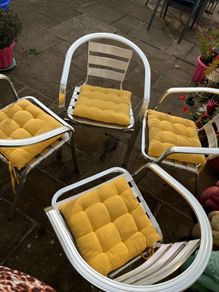 Set of garden or patio chairs with matching cushions