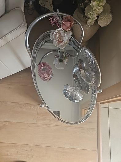 drinks trolly and large flower arrangement with vase