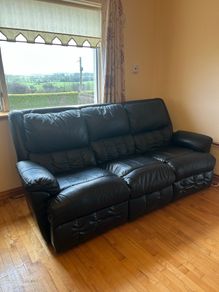 black reclining leather sofa and two armchairs