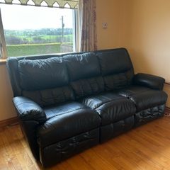 black reclining leather sofa and two armchairs