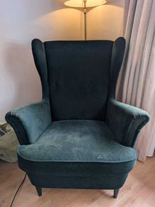 High backed winged armchair