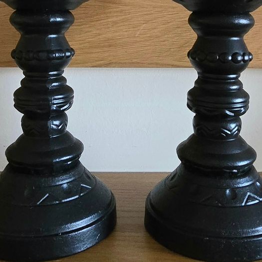 A pair of black candle holders