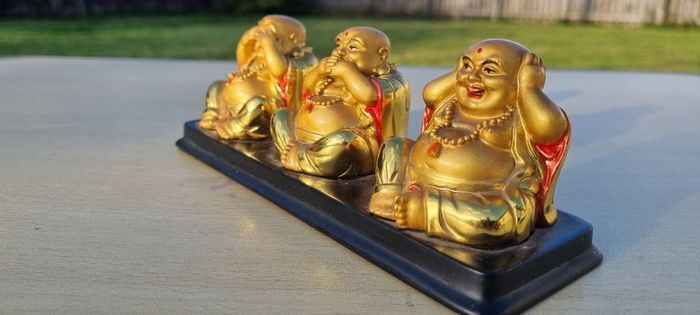Three brass Buddha figurines