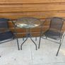 Small glass top garden table and x2 metal frame chairs Image 2