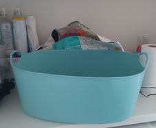Large blue plastic laundry basket