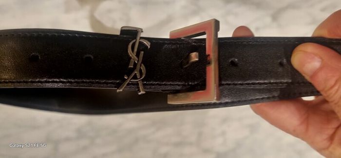 Black leather belt in the style of designer
