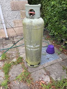 Empty 47kg propane gas cylinder and connection