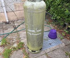 Empty 47kg propane gas cylinder and connection