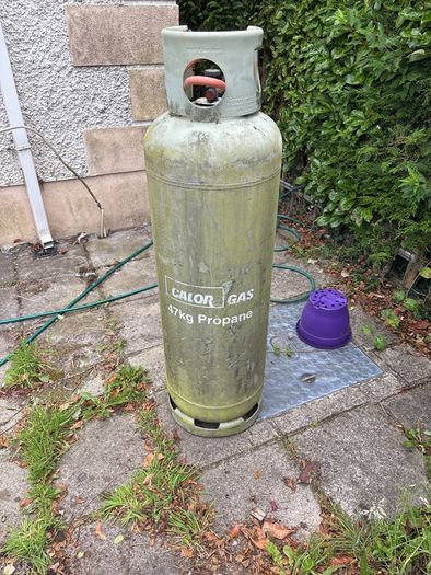 Empty 47kg propane gas cylinder and connection