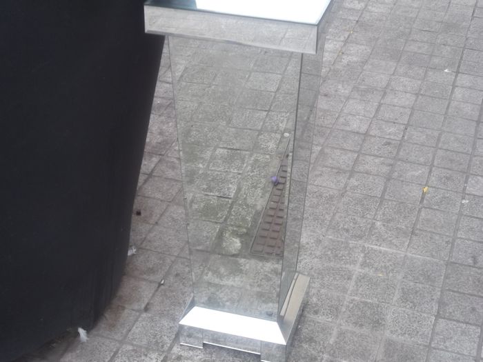 a shops display stand with mirror all round it