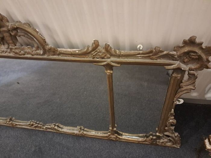 Two distinct antique giltwood mirrors with elaborate French-style ornamentation