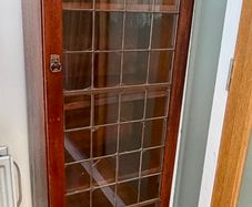 Vintage wooden display cabinet with glass door