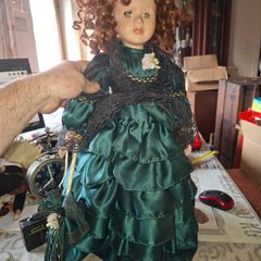 Vintage Large Victorian-style collectible Porcelain Doll featuring curly reddish-brown hair and a multi-layered emerald green satin and lace dress