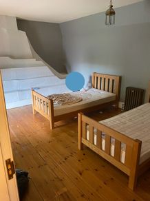 Two matching solid oak single beds.