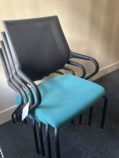 Office chairs with black frames and teal seats
