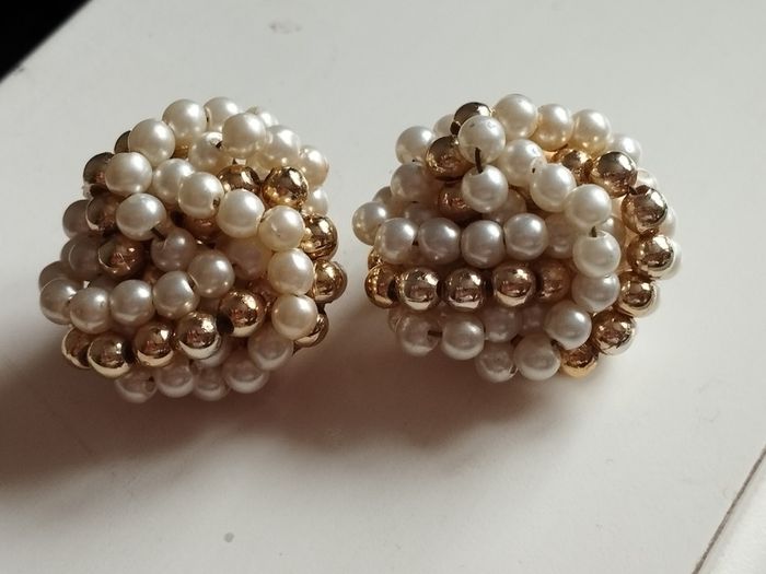 Vintage clip-on earrings with a cluster of faux pearls and gold-tone beads.