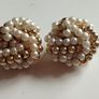 Vintage clip-on earrings with a cluster of faux pearls and gold-tone beads. Image 2