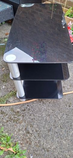 Black glass TV stand with silver legs
