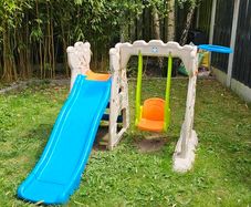 Outdoor play centre with slide and swing