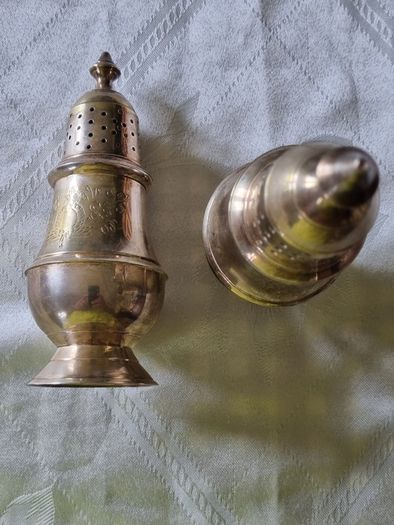 A pair of silver-plated salt shakers