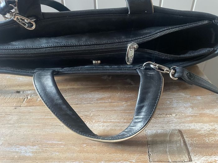 Tula black leather tote bag with a shoulder strap.