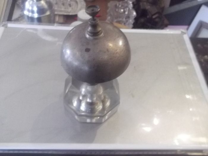 a antique counter bell with a cut glass base