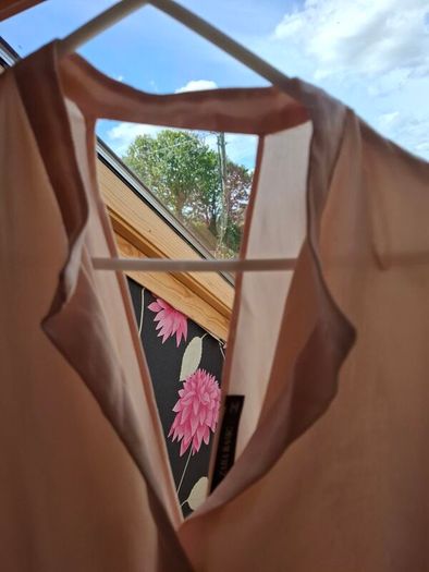 Blush coloured blouse.