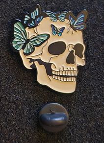 Skull/ butterfly, pin back badge.