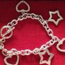 A fashionable bracelet with silver-tone charms. Image 6