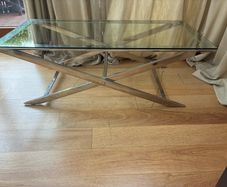 Contemporary glass top and polished metal coffee table