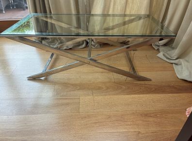 Contemporary glass top and polished metal coffee table