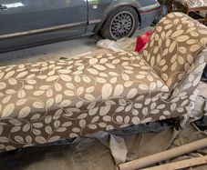 Newly upholstered Edwardian ottoman chaise lounge with plush velvet-lined interior.