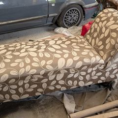 Newly upholstered Edwardian ottoman chaise lounge with plush velvet-lined interior.