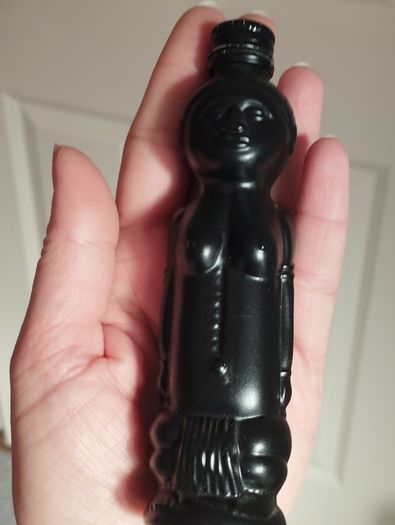 Vintage miniature "VUDU" bottle made of opaque black glass.