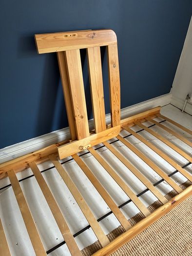 Single slatted wooden bed