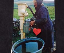 Ireland Postcard : Showing An Elderly Lady Using A Hand Pump In Rural Ireland