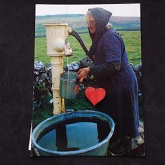 Ireland Postcard : Showing An Elderly Lady Using A Hand Pump In Rural Ireland