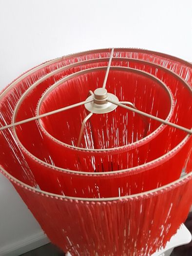 Orange fringed lamp on bass base