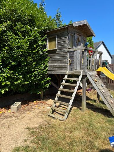 treehouse with swings slide climbing wall and gym bar