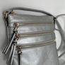Silver crossbody handbag with contrasting gold zips & hardware  In excellent condition. Purchased in Toulouse Image 8