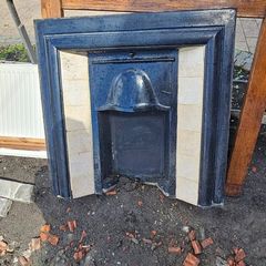 Metal and tiled fireplace with wooden mantle. With 4 panel internal door