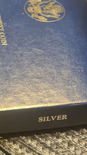 American 1986s silver dollar. Ellis Island