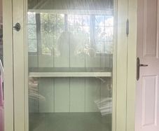 Sage green tall wooden glass cabinet