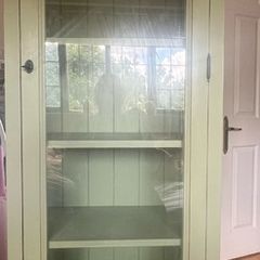 Sage green tall storage cabinet