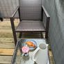 Brown rattan outdoor table and rocking chair Image 2