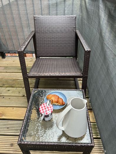Brown rattan outdoor table and rocking chair