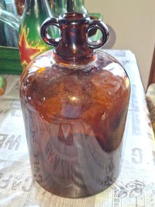 2 Demijohn Jars, Amber and Clear glass,  Stage or Movie Props collectible. Postage Available or Collection