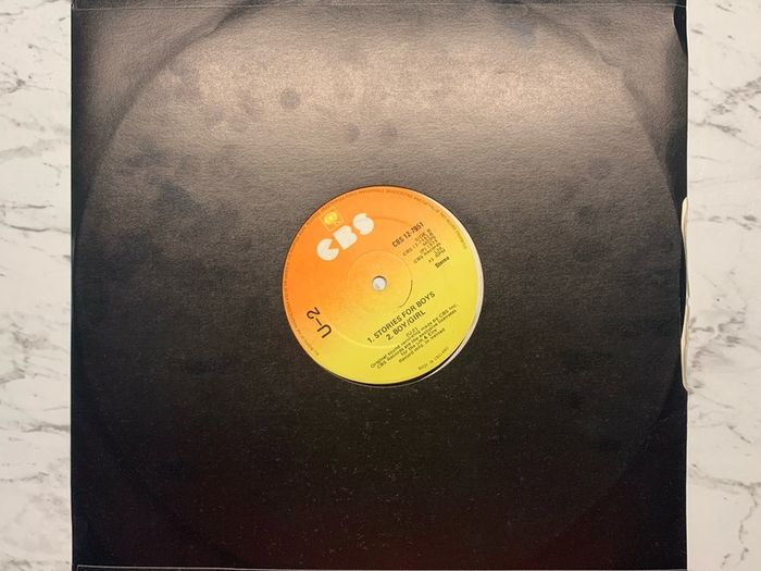 U2 - "Three" - 12" Vinyl  from 1979 - CBS 12-7951 - Second Release - Plain Black Sleeve, CBS Sunburst Labels